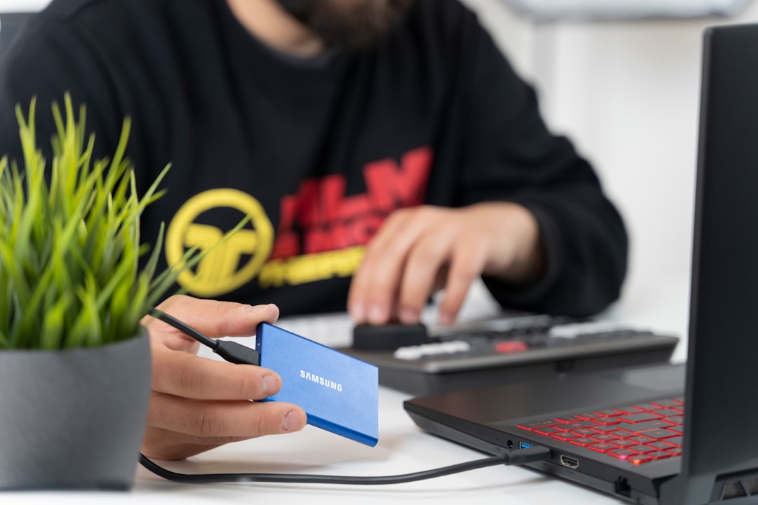 Designer examining NFC-enabled business card on tablet